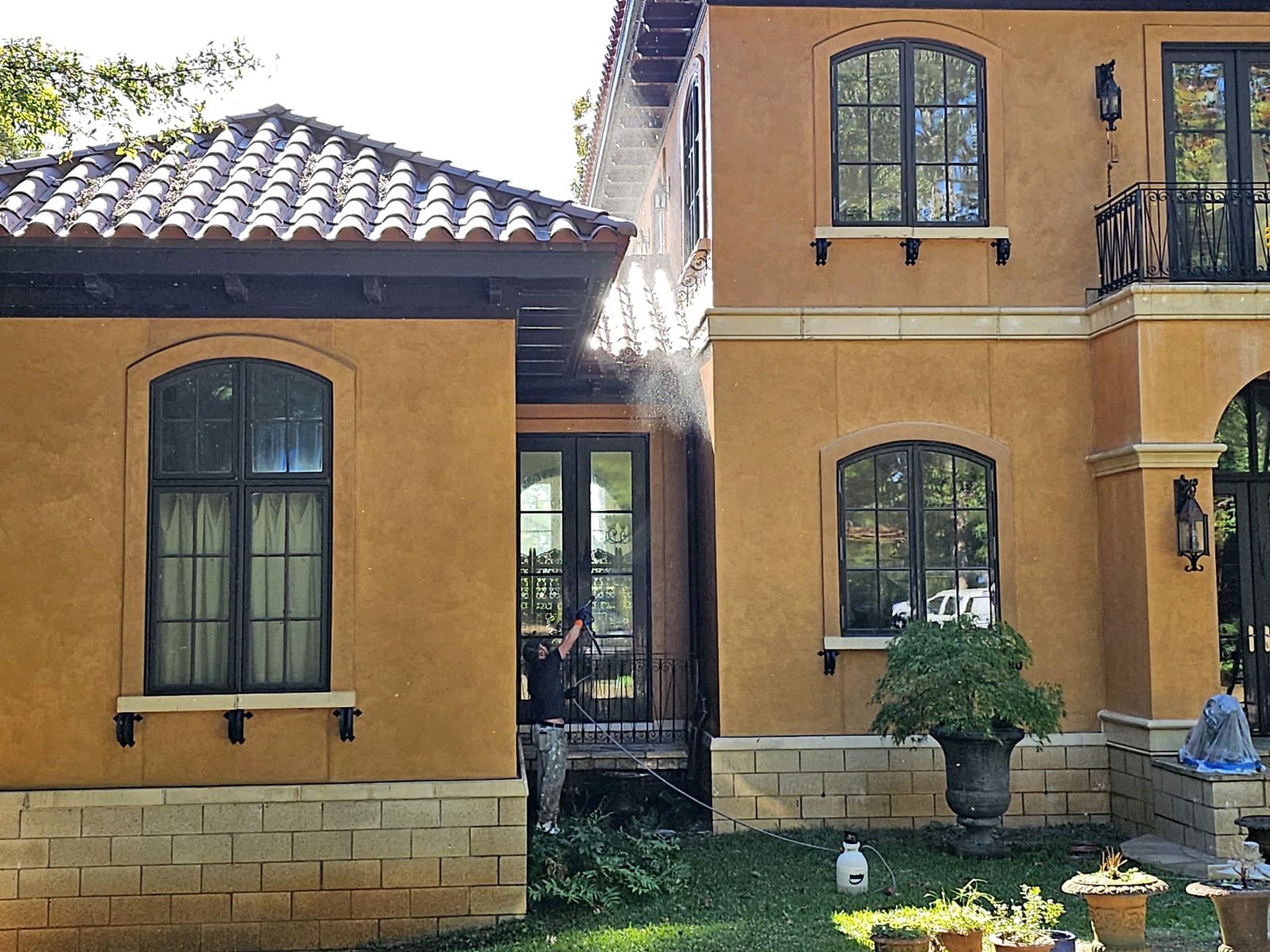 Stucco storefront, stained before and clean after